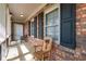 Charming covered porch with brick accents and ample seating area at 4220 Smith Rd, Loganville, GA 30052