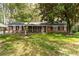 Traditional brick home featuring a lush green lawn and inviting front porch at 4220 Smith Rd, Loganville, GA 30052