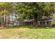 Charming brick home with a well-manicured lawn and mature trees at 4220 Smith Rd, Loganville, GA 30052