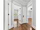 Hallway featuring hardwood floors and white trim, leading to bedrooms with natural light at 4220 Smith Rd, Loganville, GA 30052