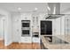 This kitchen features granite countertops, stainless appliances, custom white cabinetry, and hardwood floors at 4220 Smith Rd, Loganville, GA 30052