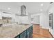 Open-concept kitchen with center island, granite counters, and modern appliances at 4220 Smith Rd, Loganville, GA 30052