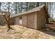 A single-story outbuilding featuring barn doors, small window, and exterior access door at 4220 Smith Rd, Loganville, GA 30052