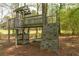 Well-maintained wooden playset with climbing wall, swing, and covered area at 4220 Smith Rd, Loganville, GA 30052