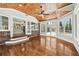 Expansive sunroom featuring wood ceilings, hardwood floors, and a view of the kitchen at 4220 Smith Rd, Loganville, GA 30052