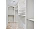 Walk-in closet features custom white shelving, ample storage, and neutral carpet at 4220 Smith Rd, Loganville, GA 30052