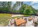 Backyard featuring outdoor dining area, basketball court, green lawn and privacy fence at 5617 Casa Blanca Ln, Atlanta, GA 30331