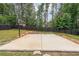 Private backyard basketball court with concrete base and tall trees surrounding a dark wooden fence at 5617 Casa Blanca Ln, Atlanta, GA 30331