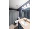Well-lit bathroom featuring a neutral color palette, shower with curtain, and updated vanity at 5617 Casa Blanca Ln, Atlanta, GA 30331