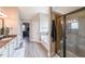 Bright bathroom boasting a glass shower, soaking tub, double vanity, and modern fixtures at 5617 Casa Blanca Ln, Atlanta, GA 30331
