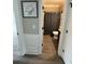 Cozy bathroom view through doorway featuring shower with grey curtain at 5617 Casa Blanca Ln, Atlanta, GA 30331
