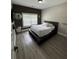 Comfortable bedroom with a wooden platform bed, updated flooring and a view to the outside at 5617 Casa Blanca Ln, Atlanta, GA 30331