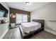 Comfortable bedroom featuring hardwood floors, a large window, and neutral paint at 5617 Casa Blanca Ln, Atlanta, GA 30331