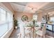 Elegant dining room featuring a glass table, stylish chandelier, and ample natural light at 5617 Casa Blanca Ln, Atlanta, GA 30331