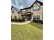 Charming two-story home with a mix of brick and stone, complemented by a lush green lawn at 5617 Casa Blanca Ln, Atlanta, GA 30331