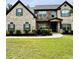 Charming two-story brick home with manicured lawn and complemented by professionally installed landscaping at 5617 Casa Blanca Ln, Atlanta, GA 30331