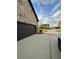 Side view of a home featuring a dark colored garage and a view to the street from the driveway at 5617 Casa Blanca Ln, Atlanta, GA 30331