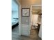 Hallway view into a bedroom with white bedding and a bathroom with shower and a vanity at 5617 Casa Blanca Ln, Atlanta, GA 30331