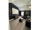 Living room with tall, dark walls, media screen and dark plush sectional at 5617 Casa Blanca Ln, Atlanta, GA 30331