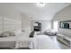 Bright and airy primary bedroom featuring a plush bed, neutral decor, and a view into media room at 5617 Casa Blanca Ln, Atlanta, GA 30331