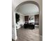 Office with wood accent wall, built in cabinetry, and arched doorway at 5617 Casa Blanca Ln, Atlanta, GA 30331