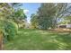 Expansive backyard featuring lush green grass and mature trees for privacy at 1830 Mayfield Rd, Alpharetta, GA 30009