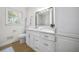 Bright bathroom features a white vanity with marble countertop, sink, and modern fixtures at 1830 Mayfield Rd, Alpharetta, GA 30009