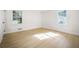 Bedroom with wood floors, two windows, and white trim, offering natural light at 1830 Mayfield Rd, Alpharetta, GA 30009