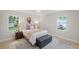 Cozy bedroom with a comfortable bed, two windows, and hardwood floors at 1830 Mayfield Rd, Alpharetta, GA 30009