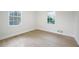 Bedroom featuring hardwood floors, two windows, and neutral walls at 1830 Mayfield Rd, Alpharetta, GA 30009