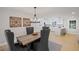 Elegant dining room with chandelier lighting, hardwood floors, and kitchen access at 1830 Mayfield Rd, Alpharetta, GA 30009
