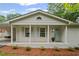 Charming home featuring a covered porch with classic columns and pastel blue shutters at 1830 Mayfield Rd, Alpharetta, GA 30009