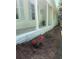 Beautifully landscaped yard with blooming azaleas lining the front porch foundation at 1830 Mayfield Rd, Alpharetta, GA 30009