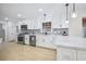 Bright kitchen featuring white cabinets, stainless steel appliances, and modern pendant lighting at 1830 Mayfield Rd, Alpharetta, GA 30009