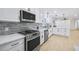 Renovated kitchen showcasing stainless steel appliances, stone backsplash, and an open-concept layout at 1830 Mayfield Rd, Alpharetta, GA 30009