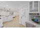 Eat-in kitchen featuring stone backsplash, white cabinets, and an office space, with hardwood flooring at 1830 Mayfield Rd, Alpharetta, GA 30009