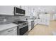 Contemporary kitchen with stainless appliances, marble countertops, and white cabinets at 1830 Mayfield Rd, Alpharetta, GA 30009