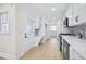 Updated kitchen with white cabinets, modern appliances, and tile backsplash at 1830 Mayfield Rd, Alpharetta, GA 30009