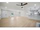 Spacious living room featuring hardwood floors, a ceiling fan, and a view of the open-concept kitchen area at 1830 Mayfield Rd, Alpharetta, GA 30009