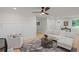 Bright living room with a ceiling fan, recessed lights, and stylish, modern decor at 1830 Mayfield Rd, Alpharetta, GA 30009