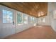 Bright sunroom with wood ceiling, brick accents, and windows at 1830 Mayfield Rd, Alpharetta, GA 30009