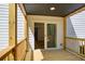 Covered back porch features deck boards, white siding, and sliding glass door at 4544 Savage Ne Dr, Marietta, GA 30066