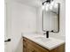 Bathroom vanity featuring square sink, modern lighting, and wooden cabinets at 4544 Savage Ne Dr, Marietta, GA 30066