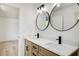 Modern bathroom features a double vanity, marble countertop, round mirrors, and contemporary fixtures at 4544 Savage Ne Dr, Marietta, GA 30066