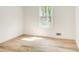 Bright bedroom with light hardwood floors, white walls, and a window at 4544 Savage Ne Dr, Marietta, GA 30066