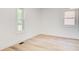 The bedroom has white walls, white trim, two windows, and LVP flooring at 4544 Savage Ne Dr, Marietta, GA 30066