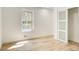 Clean and bright bedroom with light hardwood floors, minimalist design, and natural light at 4544 Savage Ne Dr, Marietta, GA 30066