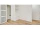 Minimalist bedroom with a closet, light hardwood floors, and white walls at 4544 Savage Ne Dr, Marietta, GA 30066