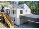 Contemporary home featuring a covered carport, dual staircases, and appealing modern architecture at 4544 Savage Ne Dr, Marietta, GA 30066