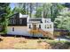 Modern two-story home with black and white accents, wooden deck, and a convenient carport at 4544 Savage Ne Dr, Marietta, GA 30066